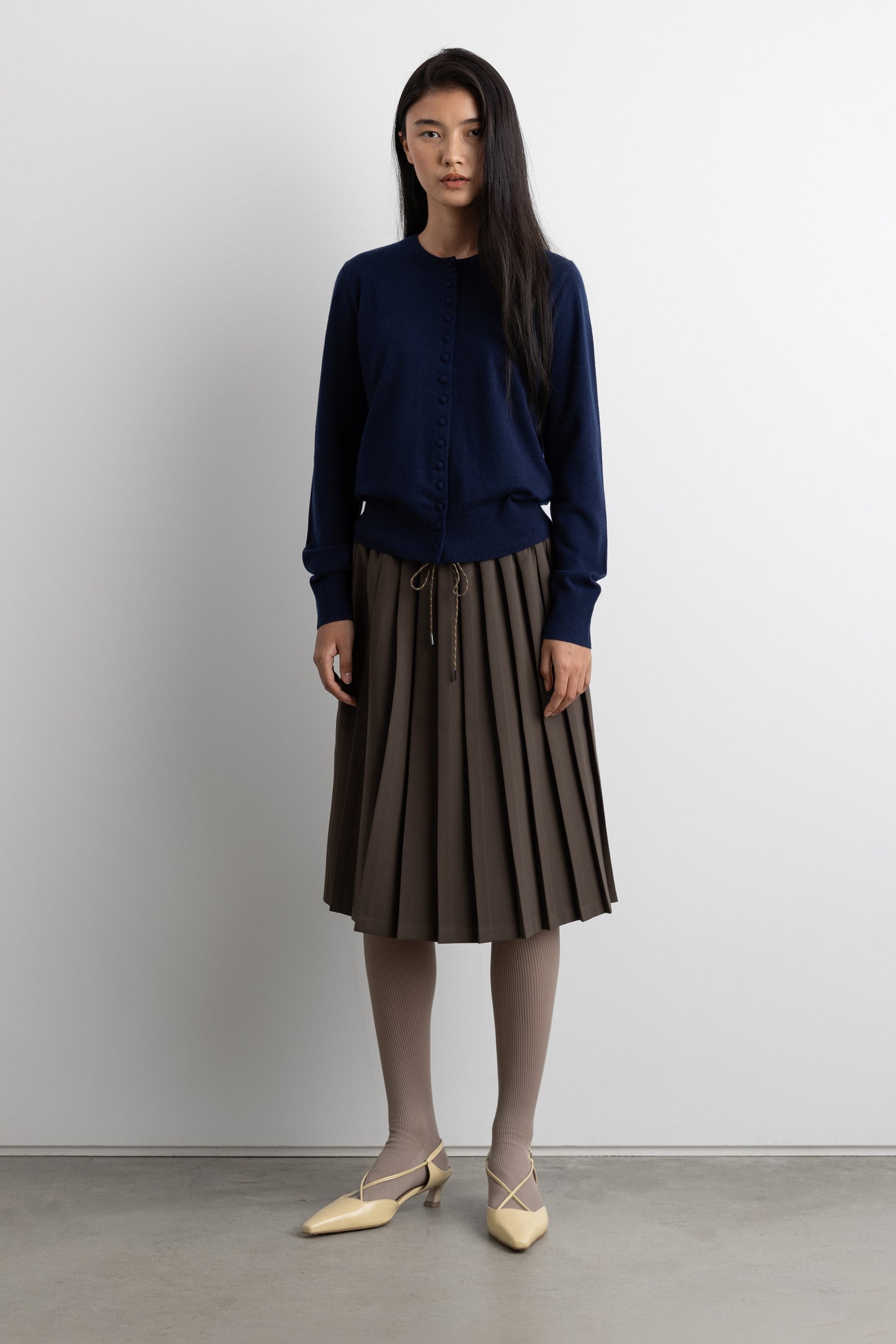 EXPOSED WAIST PLEATED MIDI SKIRT